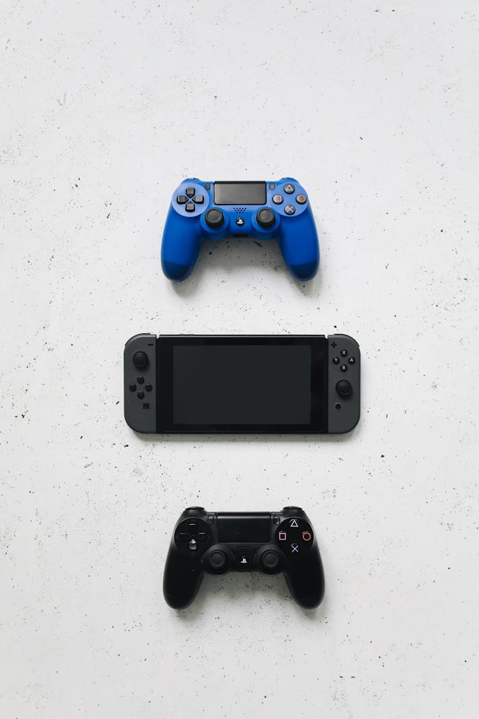 Top view of various game controllers arranged on a white surface.